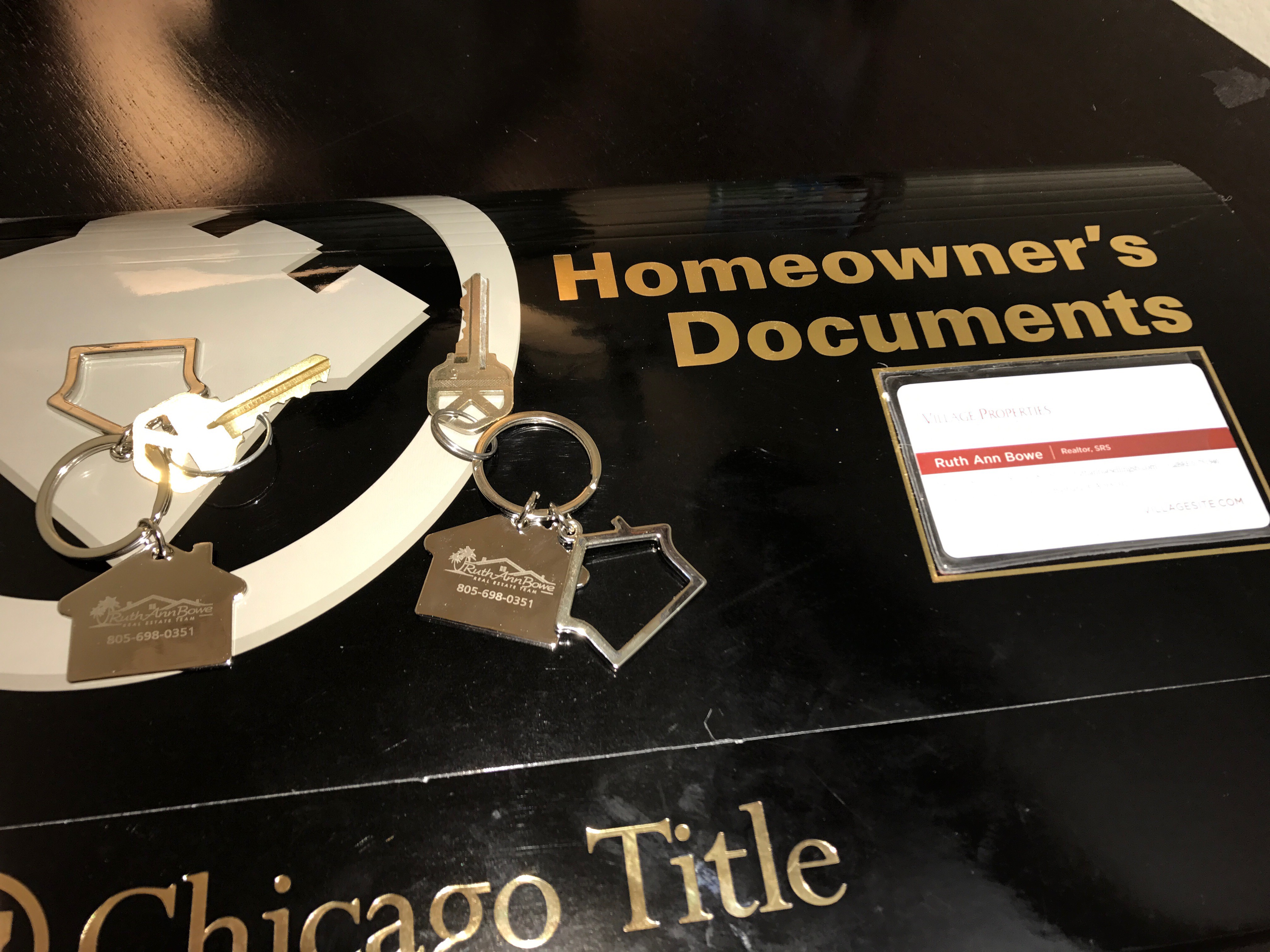 Keys to a new home along with documents folder