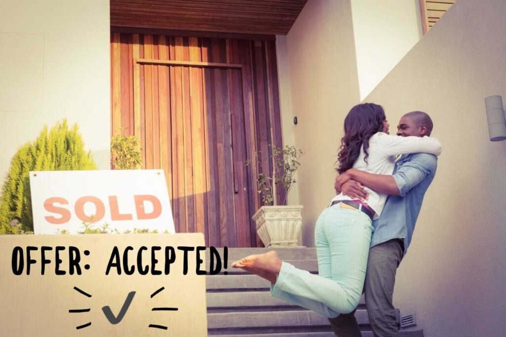 Happy couple hugging after buying a house